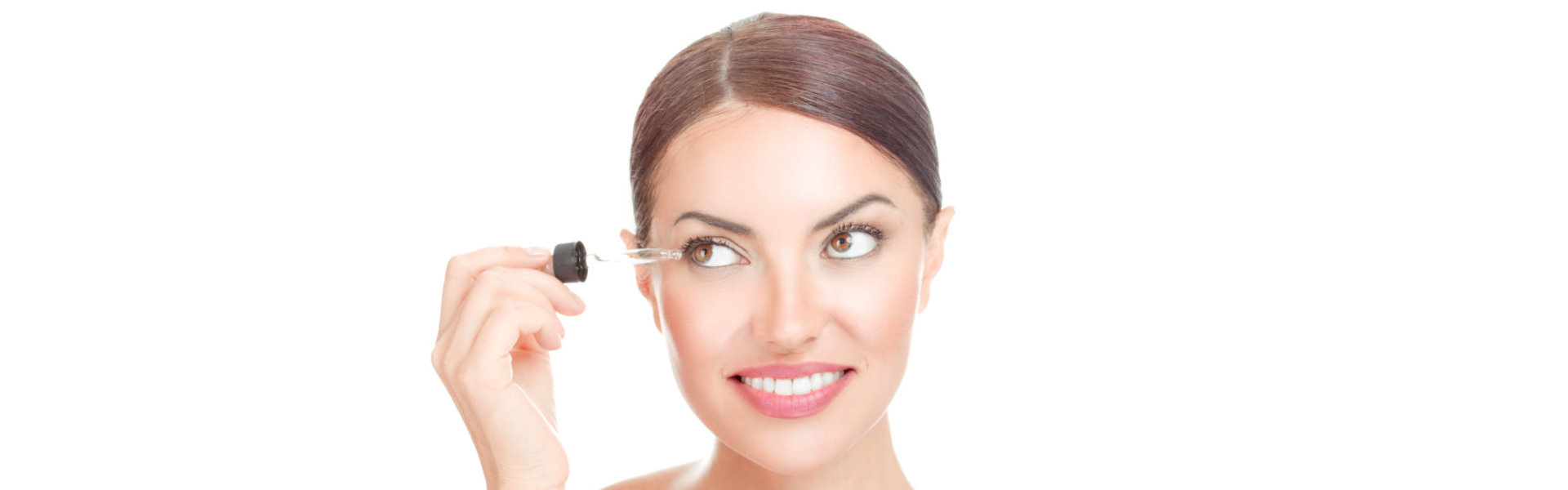 a woman applying serum on eyebrows