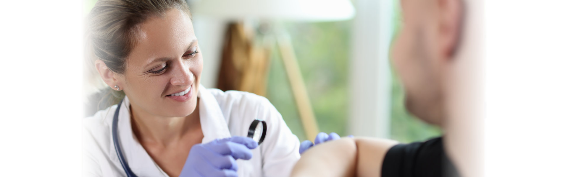 doctor examines patient's arm