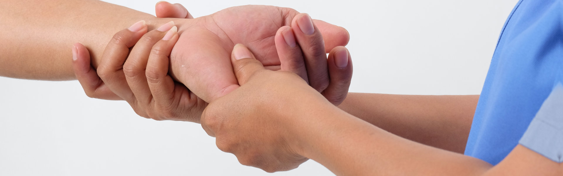 doctor checks the hand of a patient