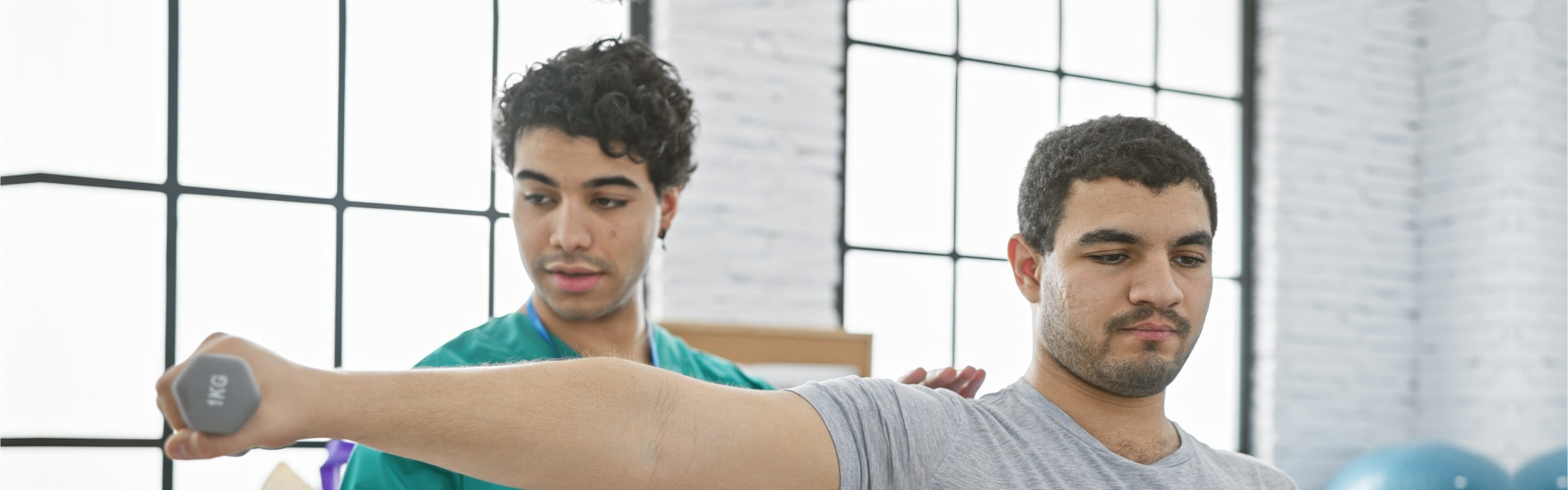 therapists guiding patient to exercise