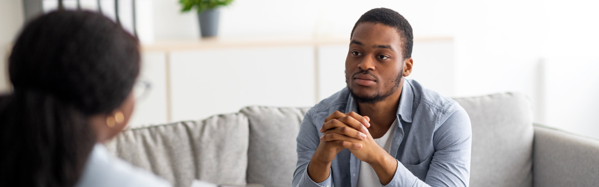 male patient having psychotherapy session with counselor