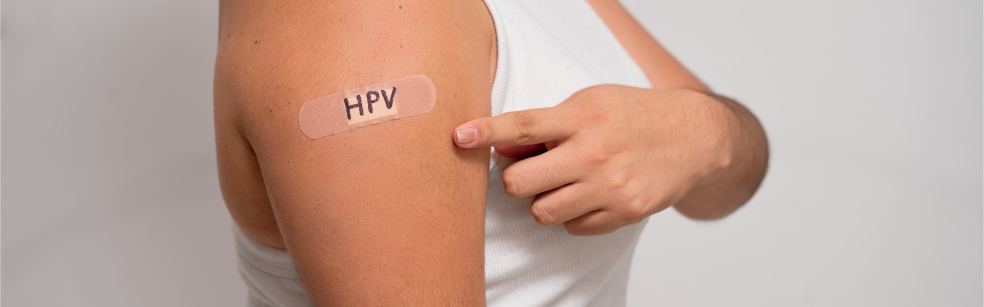 oman showing off an bandage after receiving the HPV vaccine